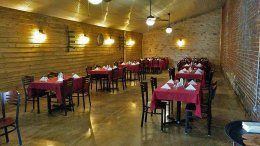 Interior view of the restaurant, showing cloth covered tables